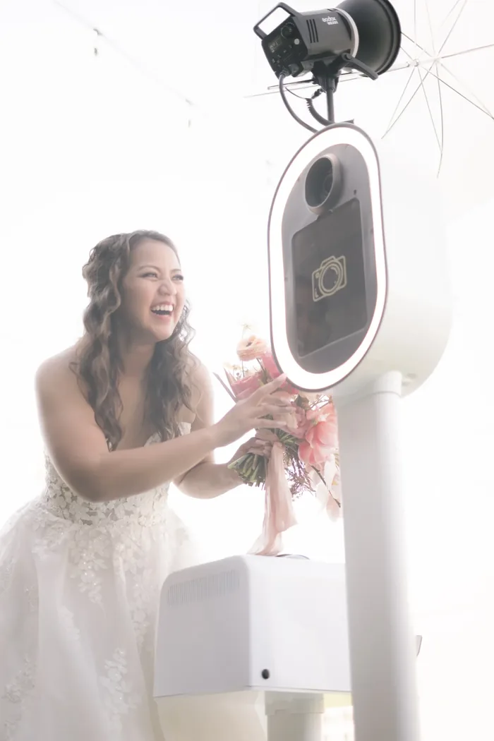 Bride laughing at photo booth rental Virginia Beach wedding