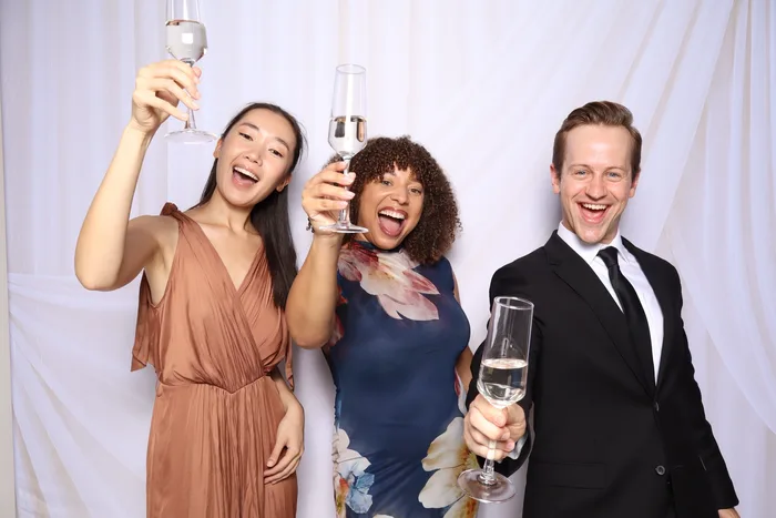 Friends toasting with champagne at photo booth Virginia Beach
