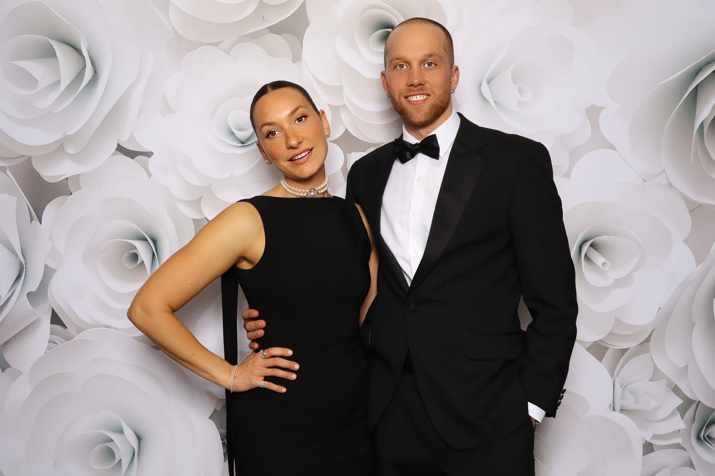 Couple at black tie photo booth with white rose backdrop Virginia Beach