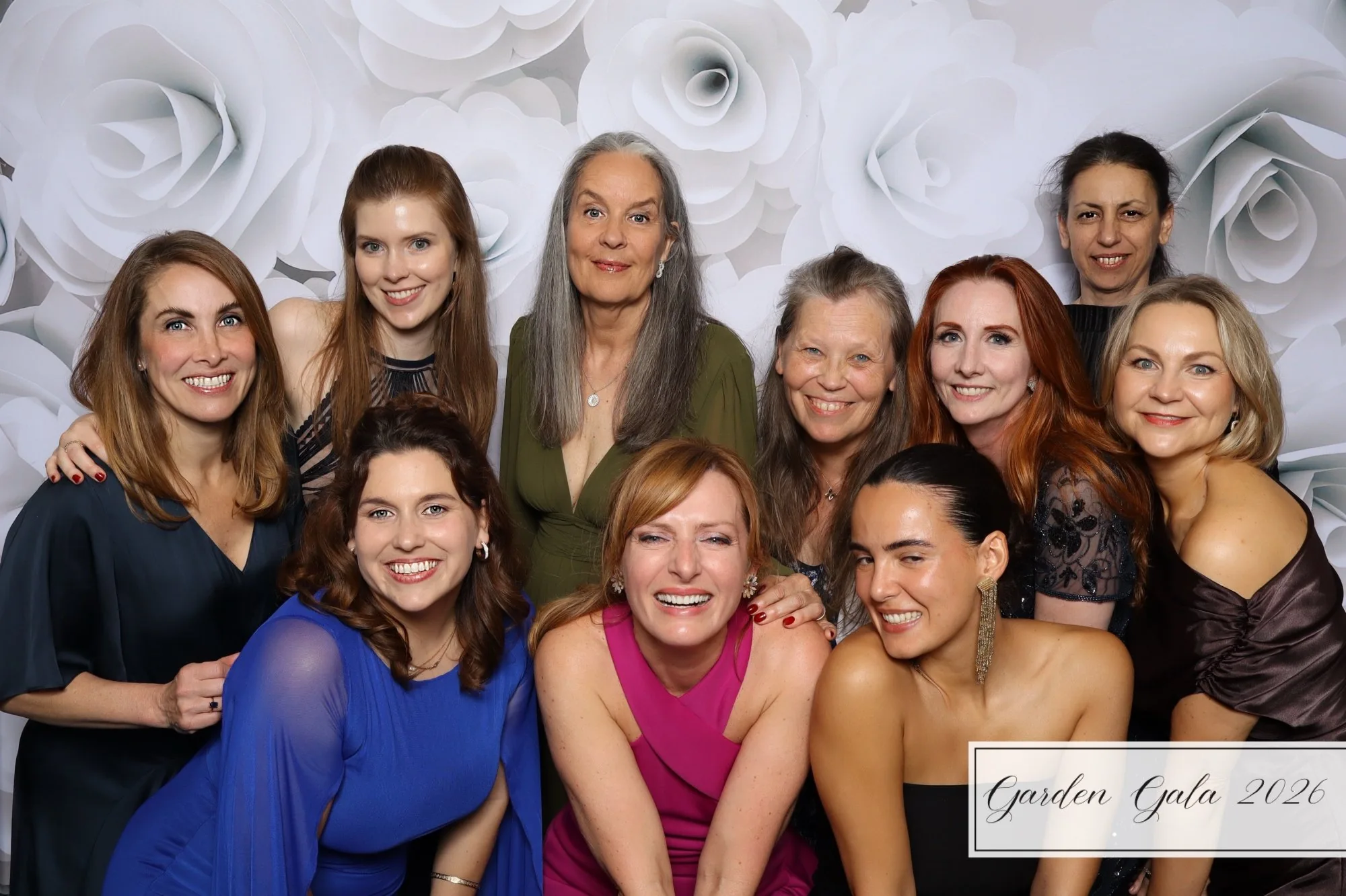 Garden Gala 2026 large women's group formal photo booth Hampton Roads Virginia — elegant white flower backdrop gala