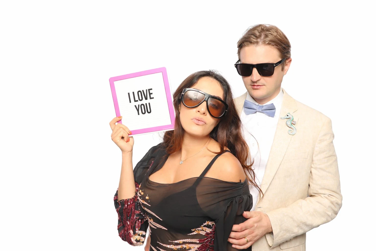 Couple with sunglasses at glam white backdrop photo booth Virginia Beach