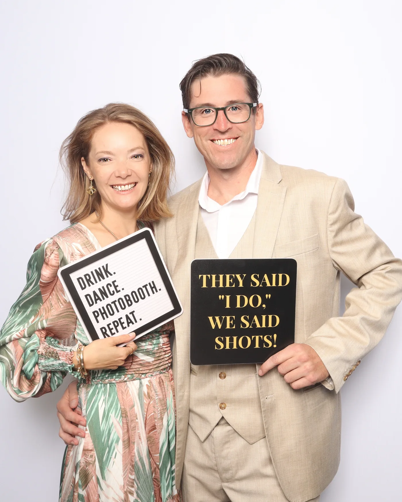 Wedding guests holding a "They Said I Do, We Said Shots!" prop sign at a photo booth — Virginia Beach
