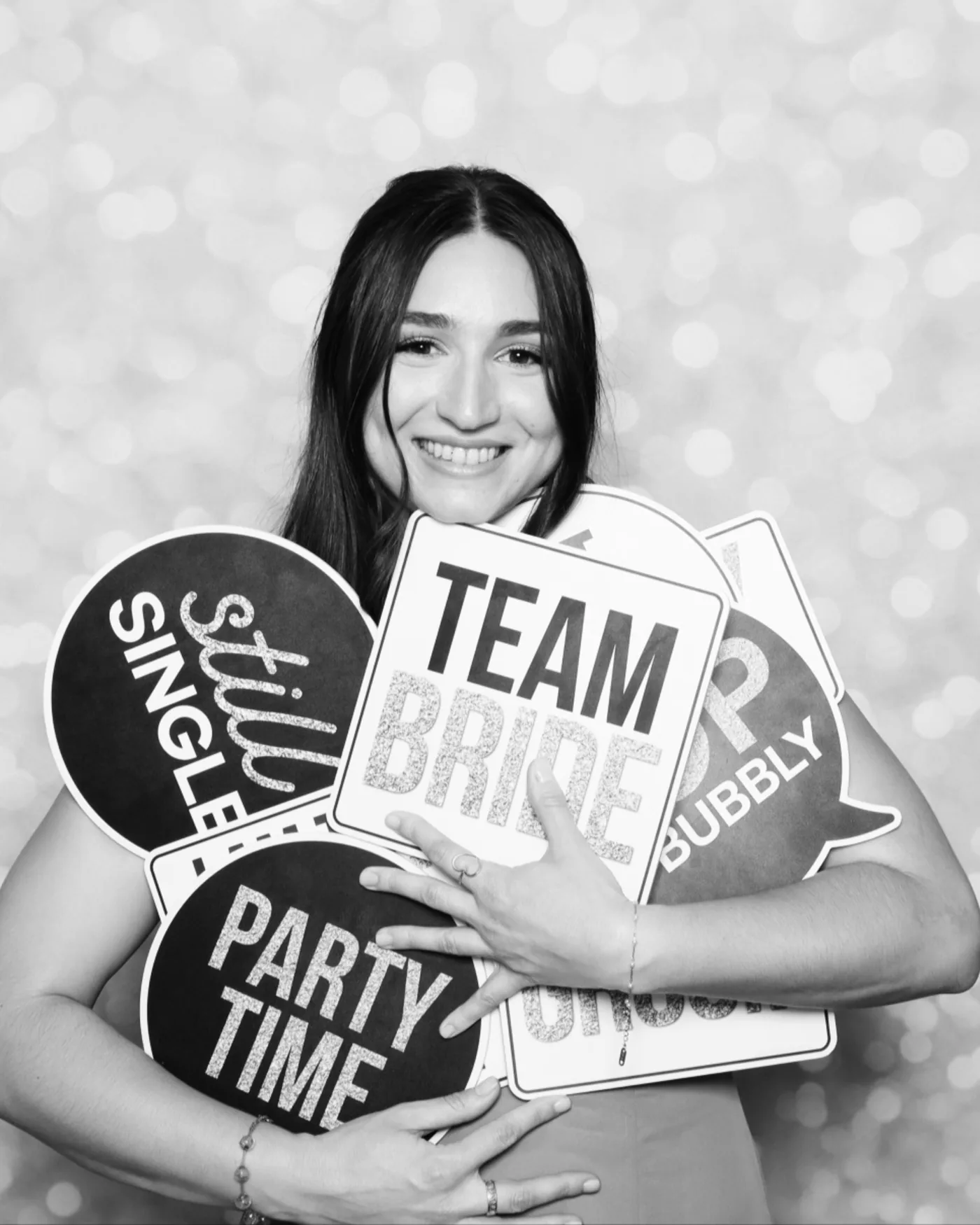 Bachelorette party guest with "Team Bride" prop signs at a photo booth — Virginia Beach