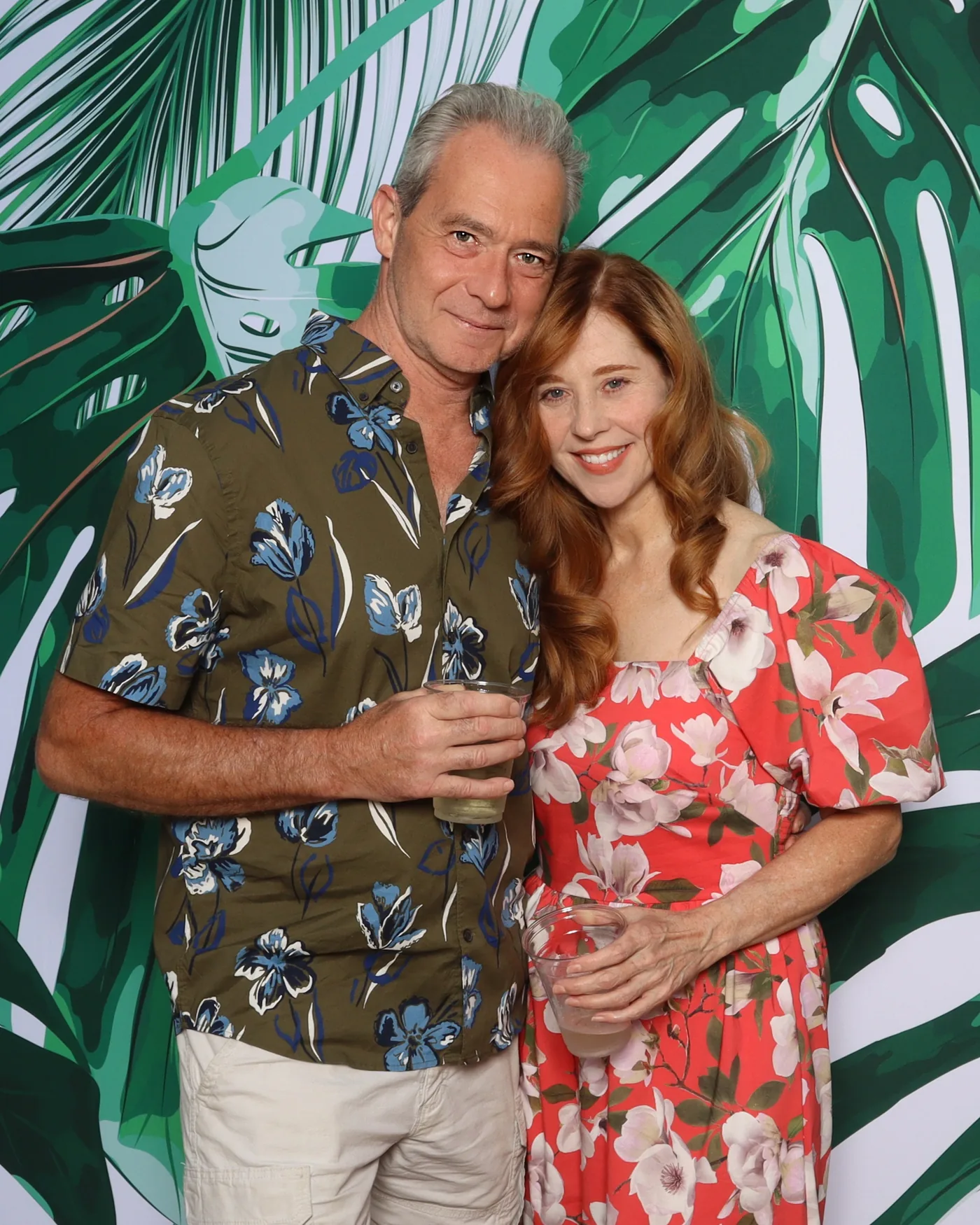 Couple at a tropical-backdrop photo booth — Virginia Beach