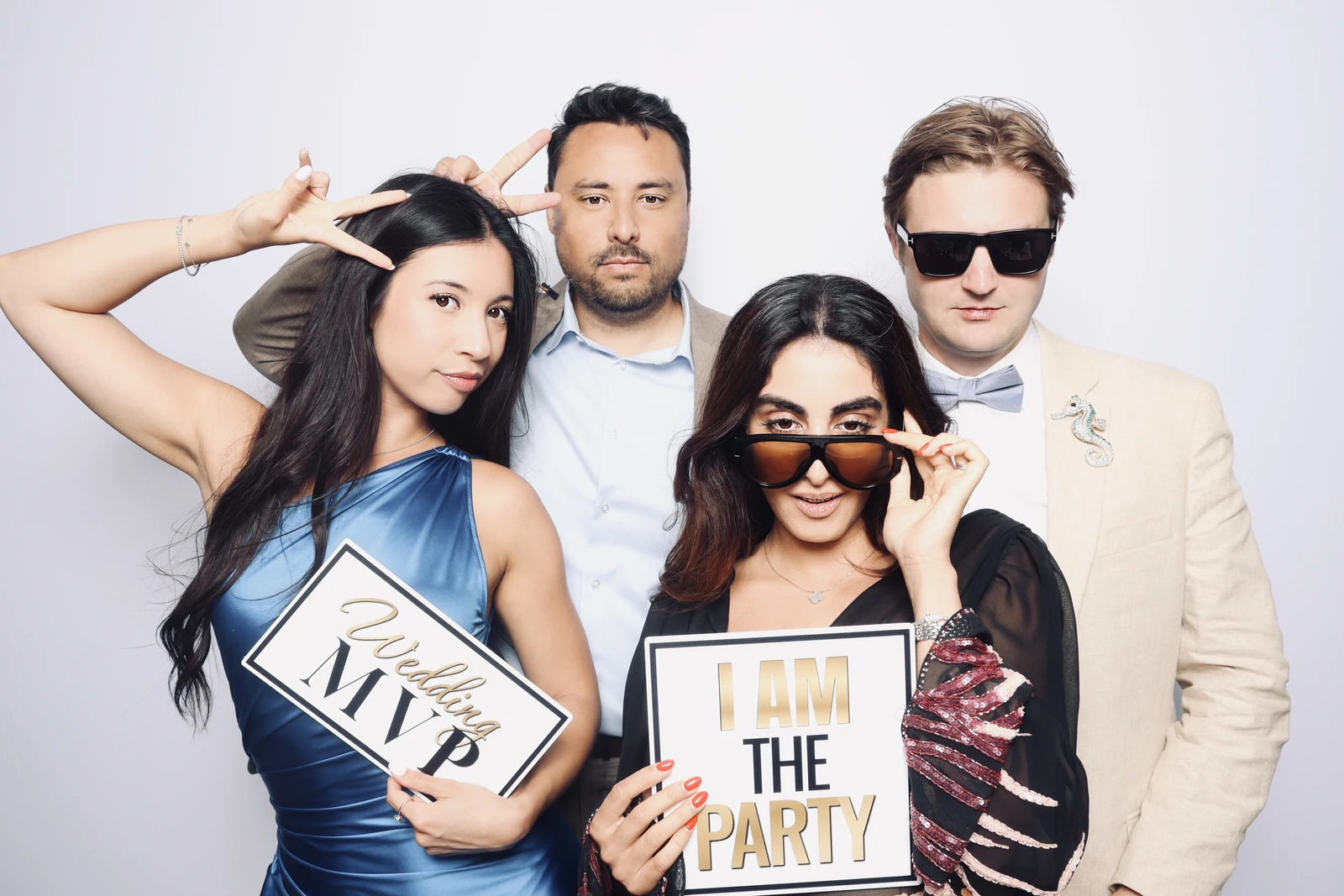 Wedding guests fun photo booth Virginia Beach — holding signs with props