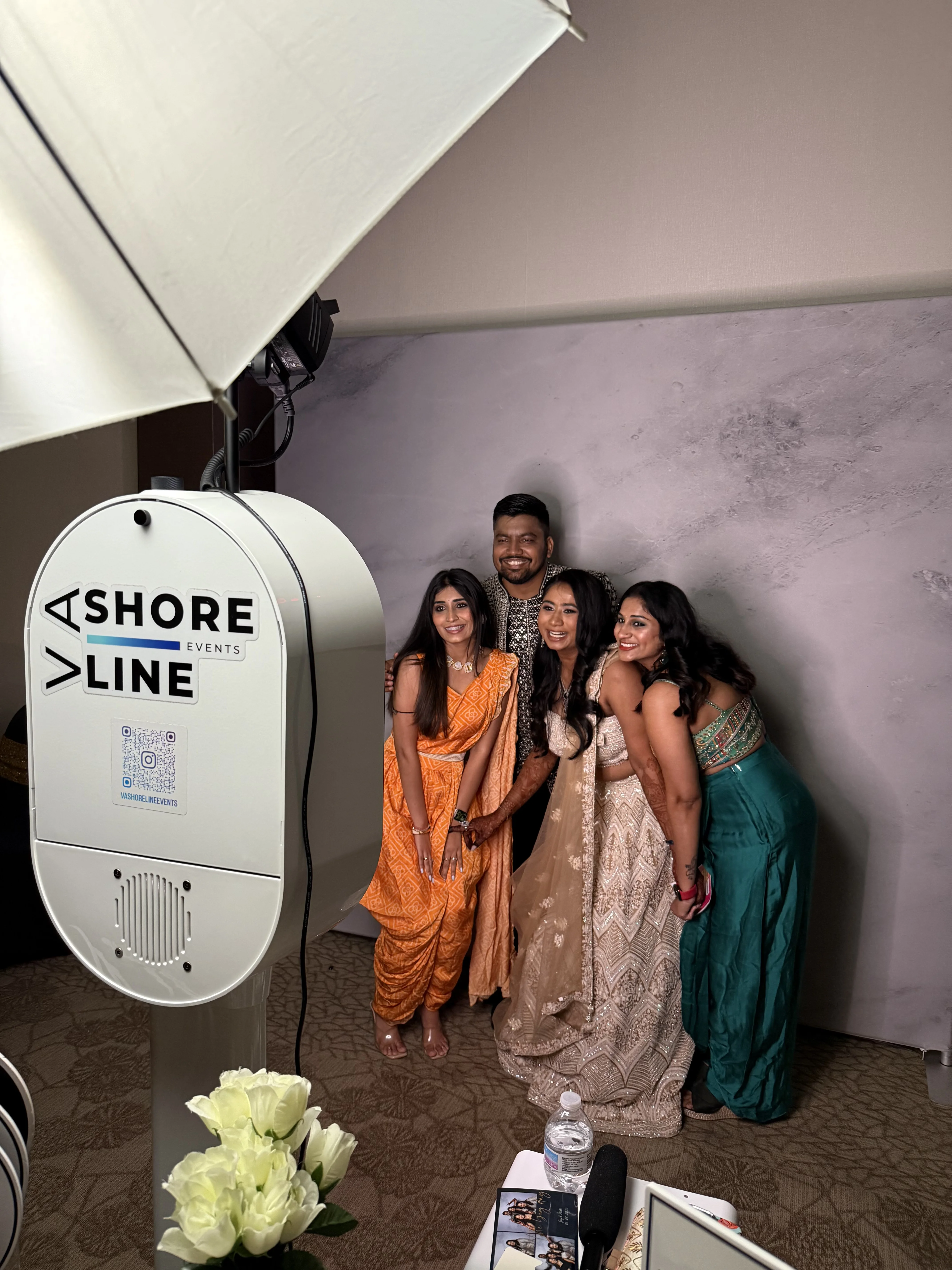 Nidhi and Jay Indian wedding guests photo booth Virginia Beach 2025 — women in traditional attire marble backdrop