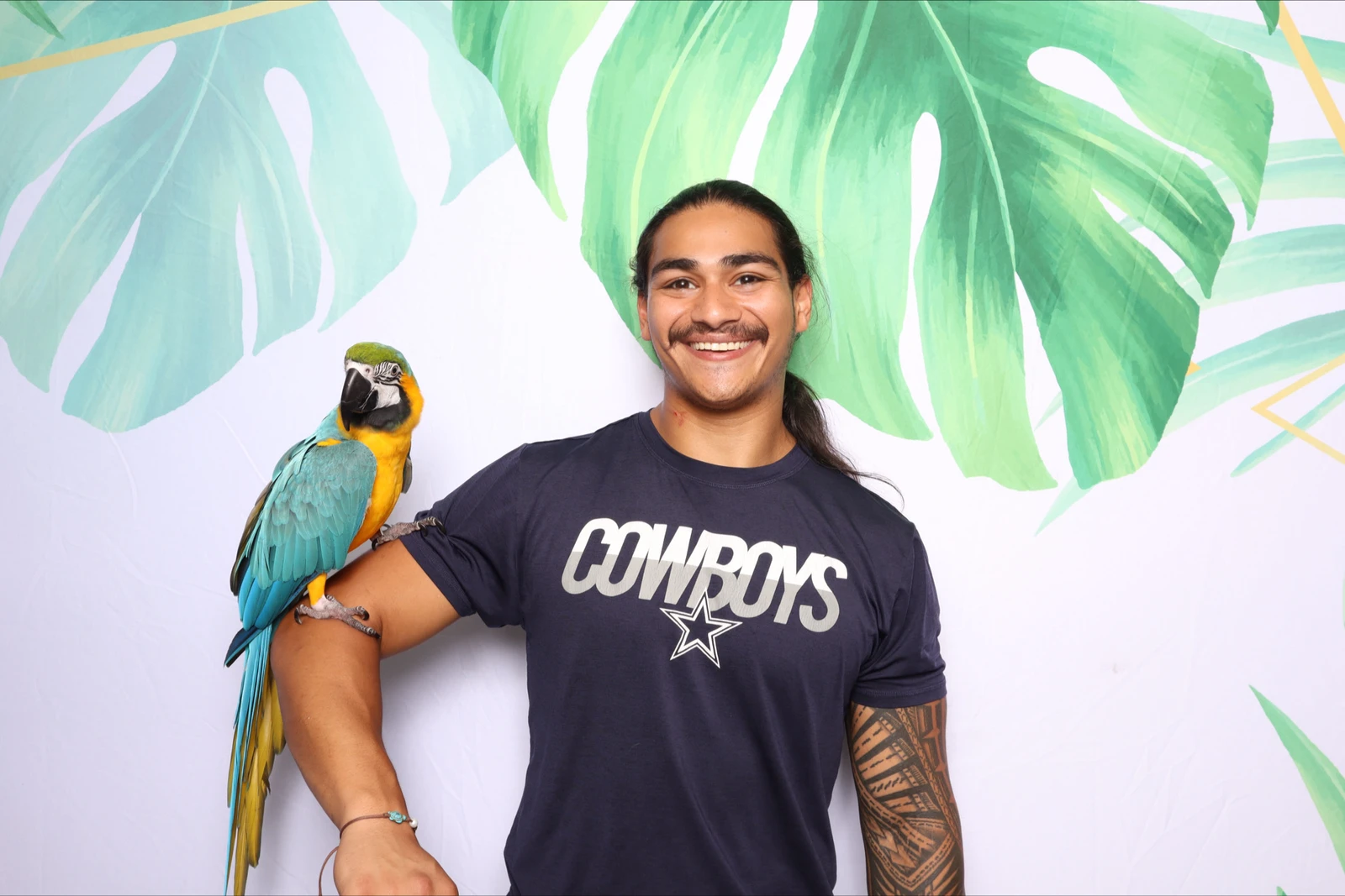 Landon's pool party fundraiser tropical photo booth Virginia Beach 2024 — guest with parrot