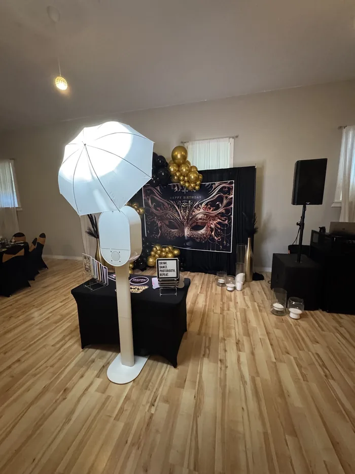 Masquerade birthday photo booth setup with black and gold balloons Virginia Beach