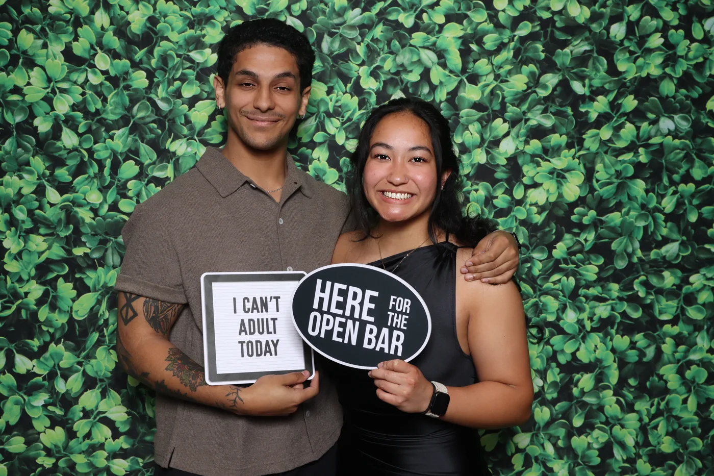 OPVRS Banquet photo booth — couple with props on greenery backdrop, Virginia Beach