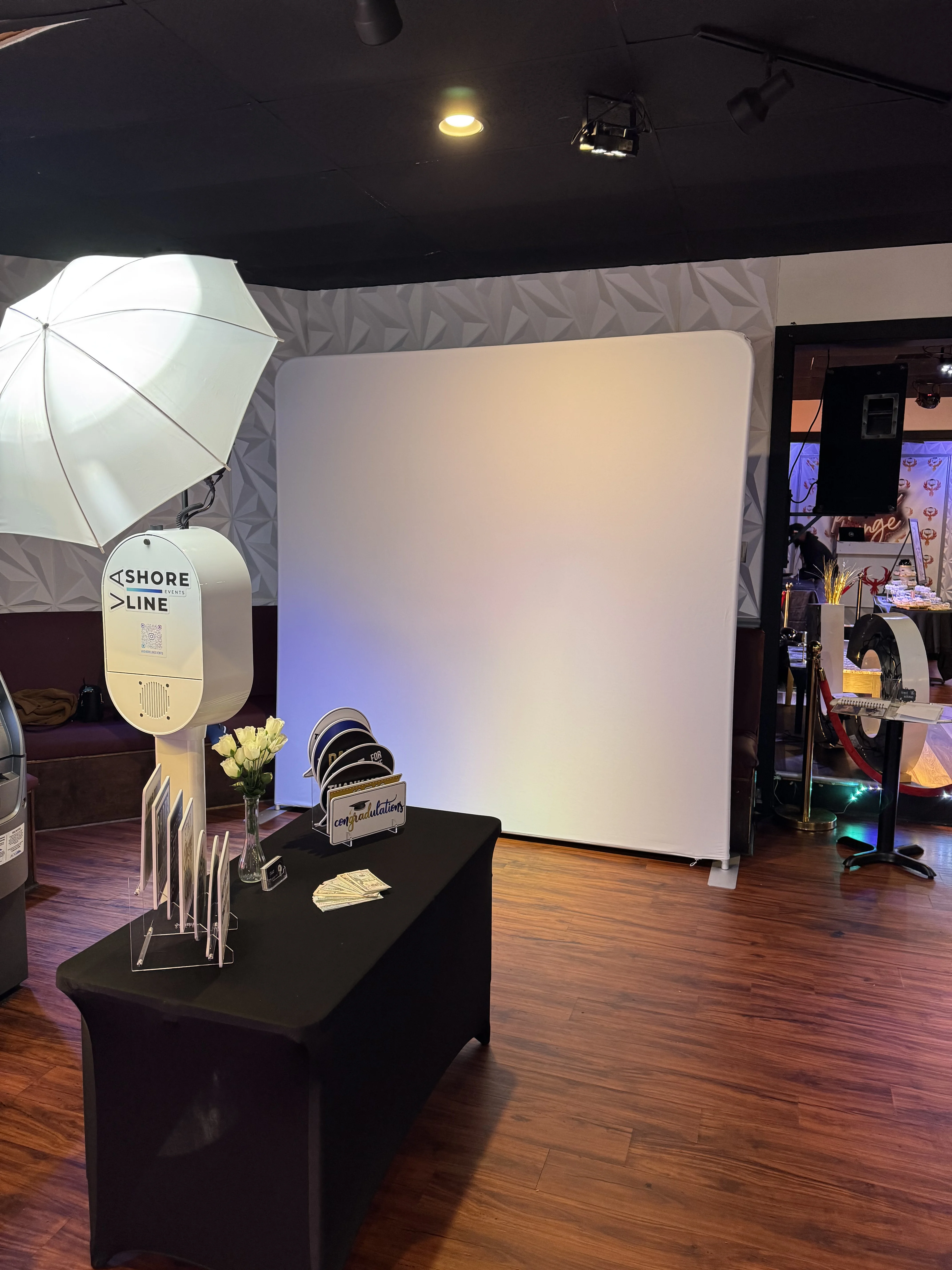 Photo booth 3D backdrop celebration Virginia Beach — elegant floral arch setup for upscale party event