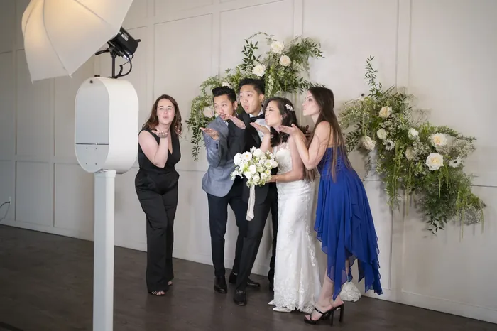 Wedding party blowing kisses at photo booth Virginia Beach
