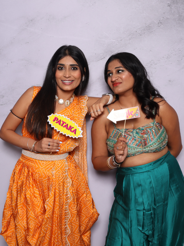 Couple posing with funny props photo booth Virginia Beach — Ready Or Not and Queen of Everything signs